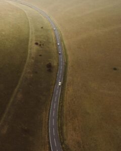 Asphalt highway between grassy fields